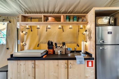 A small kitchenette providing all the things you need to cook a meal.