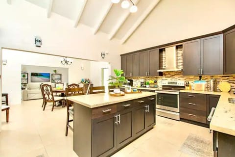 Nicely equipped kitchen looking into dining and living rooms.