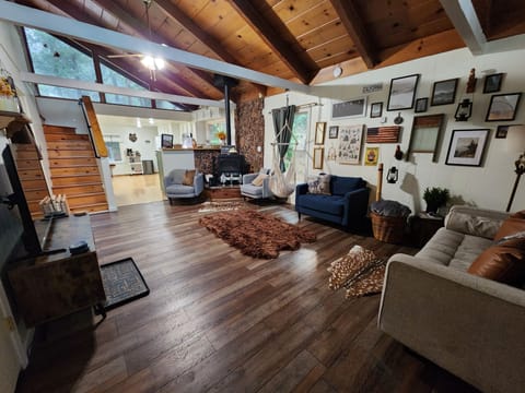 Tall ceilings in A frame home with swing chair and plenty of space