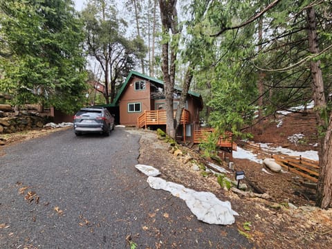 front of home with large driveway for several vehicles, carport as well.