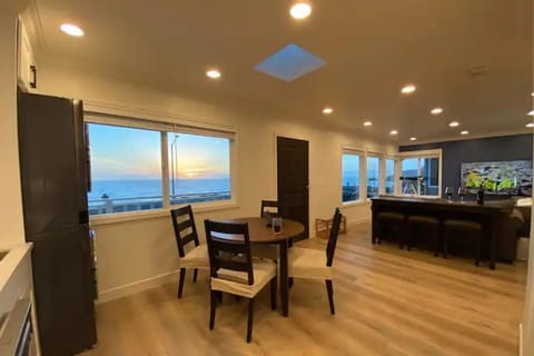 The kitchen and living room with many windows facing the Pacific Ocean