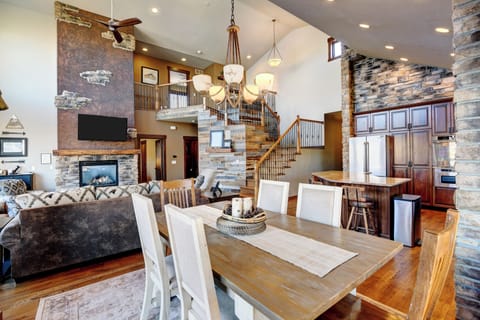 Relax in open living area with Mountain Views, fireplace and dining room