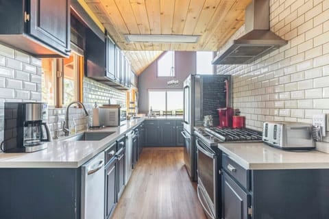 Upscale kitchen that's fully stocked. Gas stove and 2 refrigerators for you!