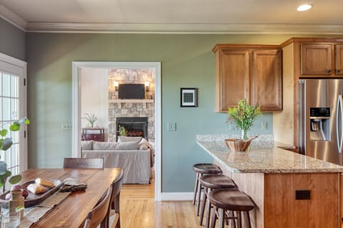 Kitchen features barstool seating and modern appliances.