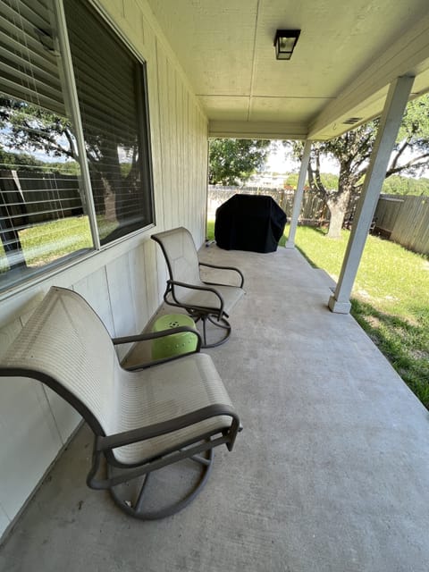 Private back patio features a gas grill and is within a fenced in yard