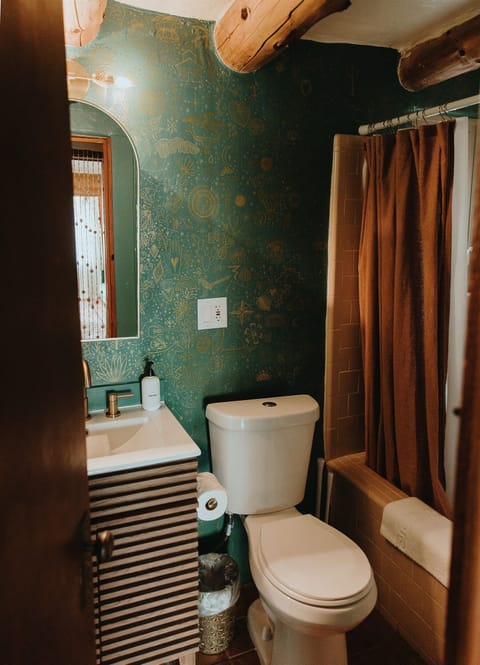 Bathroom with hand painted wallpaper by NM artist Honor Heindl