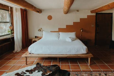 King memory foam bed with custom mural by NM artist Honor Heindl