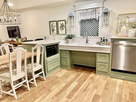 accessible microwave with pull out shelf underneath the microwave.