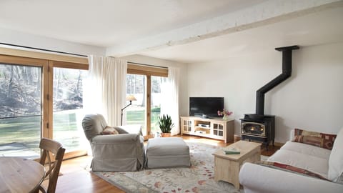 Relax in the sunny south-facing great room with a cozy gas-fueled fire stove…
