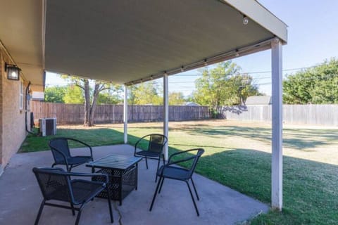 enjoy a relaxing evening under the shaded patio with string lights and grill