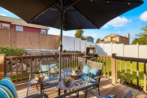 Step outside and immerse yourself in the inviting outdoor space of this deck, complete with comfortable tables and chairs.