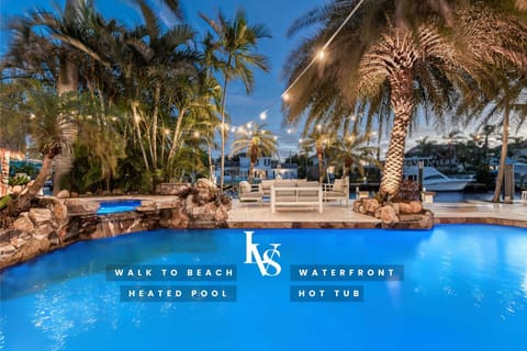 Waterfront Resort Style Oasis with Salt Water Heated Pool, Spa, FIre Pit, Tiki Hut & Bar, Outdoor Kitchen, Outdoor Dining Area, 80' Deep Water Dock / Floating Dock with no fixed bridges to Intercoastal. Plenty of Seating Areas, a Hammock & much mor