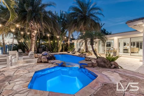 Waterfront Resort Style Oasis with Salt Water Heated Pool, Spa, FIre Pit, Tiki Hut & Bar, Outdoor Kitchen, Outdoor Dining Area, 80' Deep Water Dock / Floating Dock with no fixed bridges to Intercoastal. Plenty of Seating Areas, a Hammock & much more!!