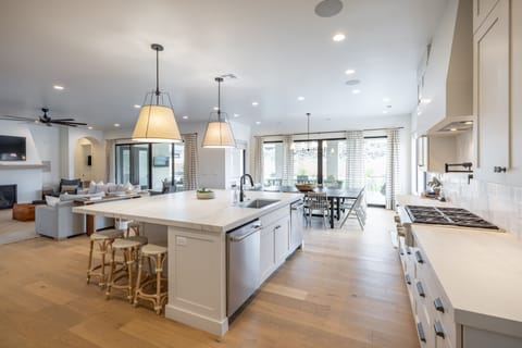 Modern Kitchen View - Side view of kitchen showing off the beautiful counter tops and stainless-steel appliances.