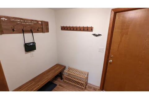 mud room with plenty of hooks for jackets, multiple shoe racks, and binoculars