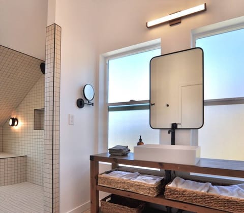 Spacious bathroom with plenty of natural light and a luxurious shower.