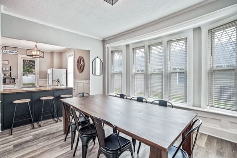 Dining room and kitchen bar, with large windows and tons of natural light.