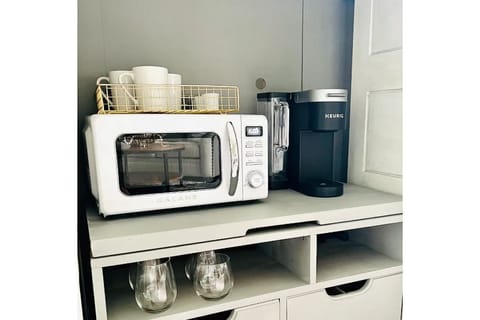 Fridge, microwave, coffee/tea maker, cookware/dishes/utensils