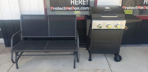 Enjoy outside on the covered patio. Glider and grill out the front door.