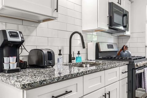 Start your day off right with a delicious breakfast made in this cozy kitchen.