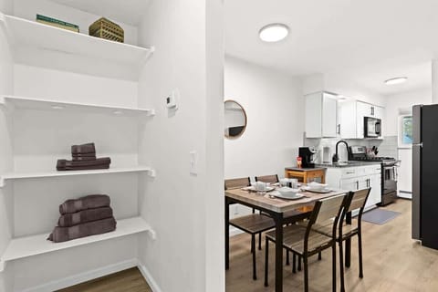 Convenient Linen Closet Equipped with Extra Towels, Cleaning Supplies, and Laundry Basket