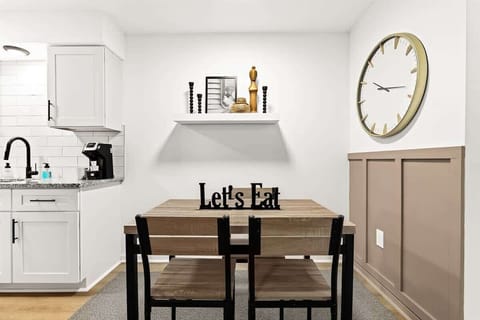 A small and cozy kitchen with a wooden table and two chairs.