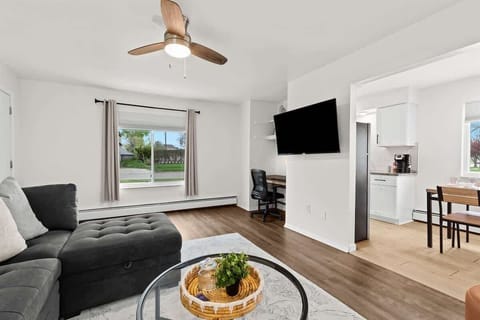 Comfy living space with work desk and mounted Smart TV