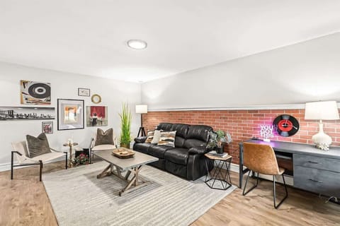 Cozy living area with comfy leather couch and work space desk