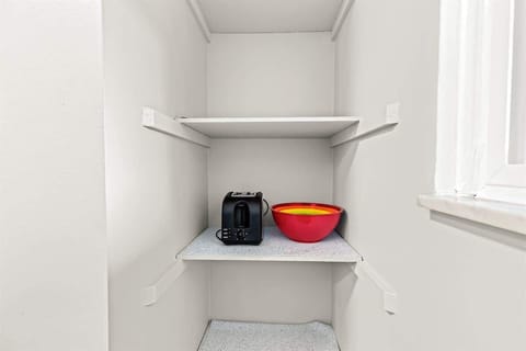 The pantry is also well-lit and has plenty of storage space, making it the perfect place to keep your groceries and kitchen supplies.