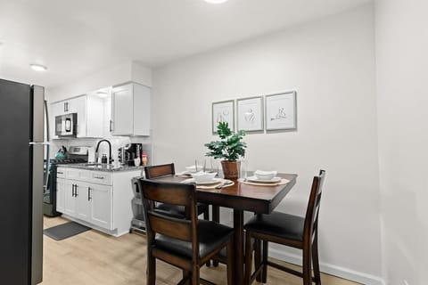 Cozy up in this charming kitchen with a table and chairs.
