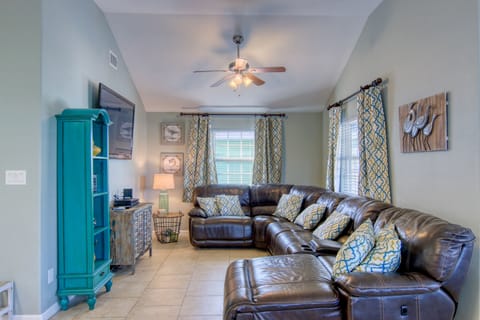 There’s plenty of comfortable seating for everyone to gather in the living room and watch a film or the big game.