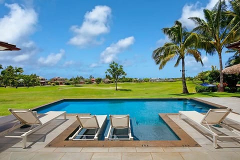 A heated pool, sun loungers