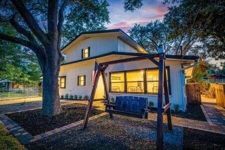 Enjoy your front yard swing under the shade of a large oak!