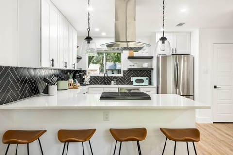 Spacious kitchen w/ ample counter space, high-top seating, and new appliances!