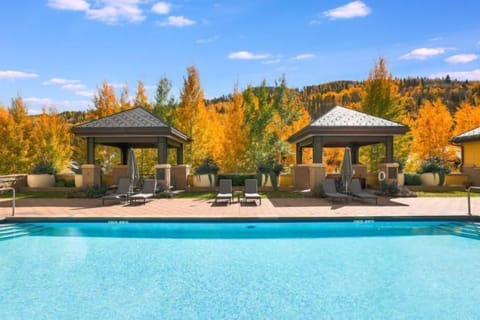 Experience premium amenities at the Ritz Carlton Residences, where an exquisite poolside oasis invites relaxation amidst the vibrant autumn landscape.