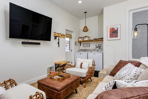 Living area with cozy seating and 65" smart tv