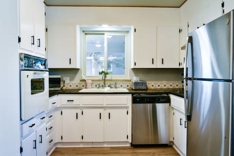 Cute little 1960s kitchen fully stocked all of your cooking needs