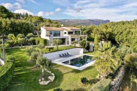 The villa, its generous pool and the beautiful gardens.