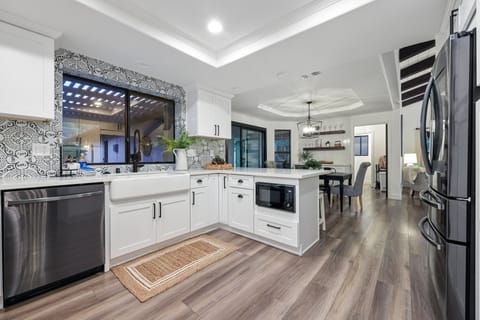 The kitchen in the main house has all new appliances and a farmhouse sink.