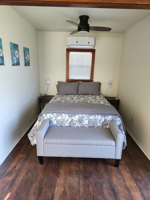 Bedroom with queen size bed, overhead fan, and AC/Heat mini split.