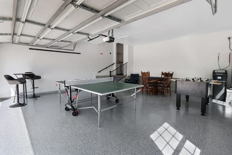 View showing entrance to home from garage. Ping pong table, foosball and game table can be seen.