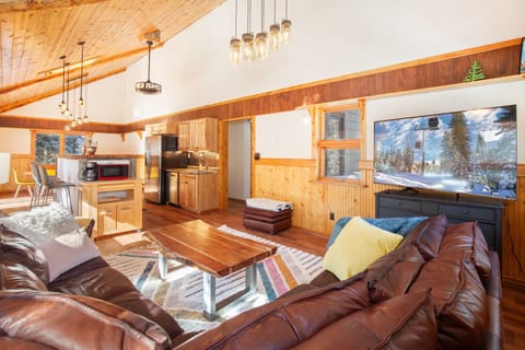 The living room, kitchen, and dining room are connected via an open floor plan.
