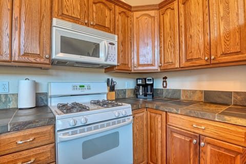 Kitchen has a stove, dishwasher and fridge