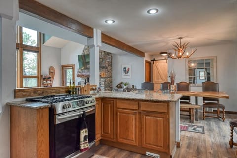 Kitchen with gas oven and all the pots and pans needed to cook a family dinner
