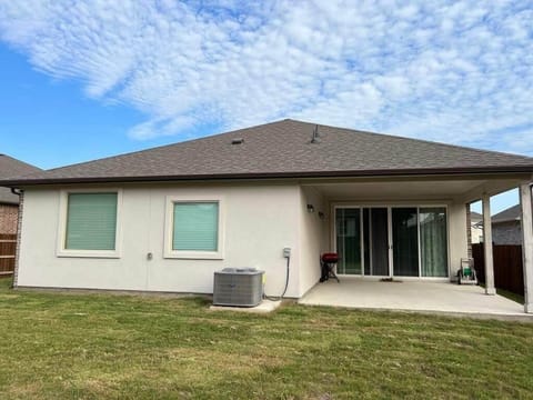 Spacious covered patio with dining table/chairs and BBQ grill provided.