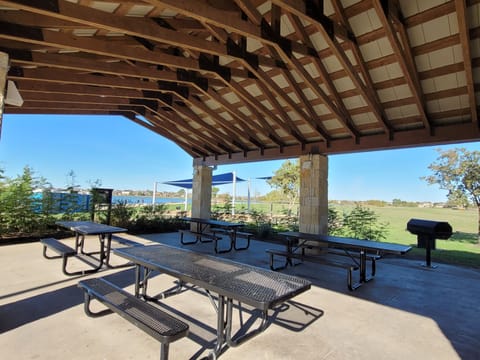 Covered picnic tables with grills and children playground
