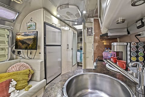 Living room and kitchen looking down towards the bathroom and queen sized bedroom. All the comforts of home in an iconic Airstream trailer in the beautiful Smoky Mountains
