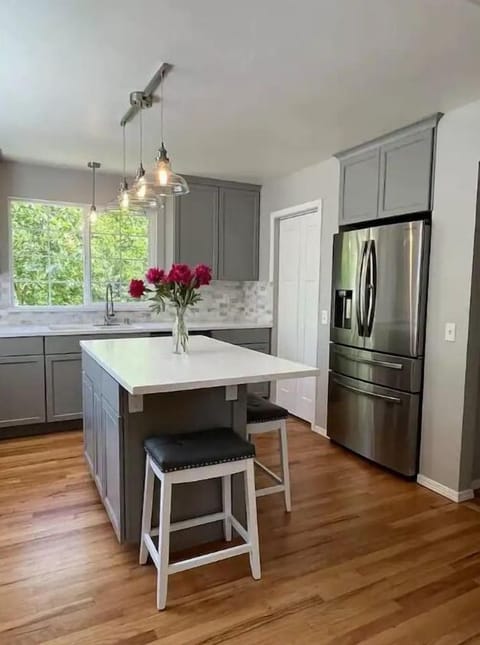 Kitchen-quartz countertops, large island, pendant lights, soft close cabinets