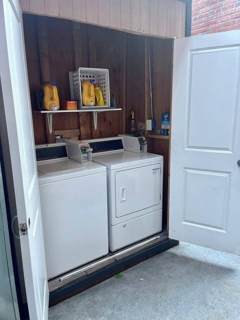 There is a building coin-op WASHER and DRYER located in the rear courtyard. Detergent is provided and you can get change from the convenience store out front