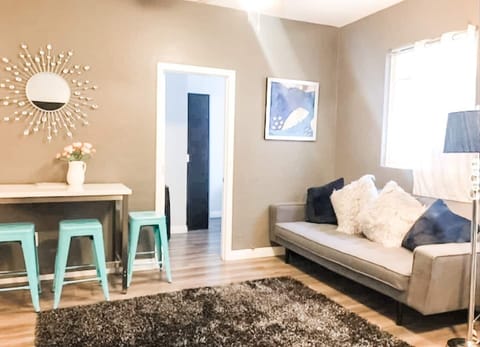 The living room area includes (1) sofa bed and (1) futon as well as a ROKU Smart TV